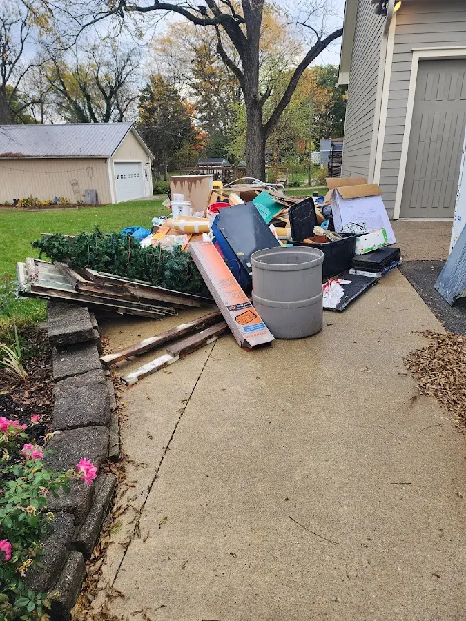 Dumpster being loaded with debris for Residential Dumpster Rental in Mansfield